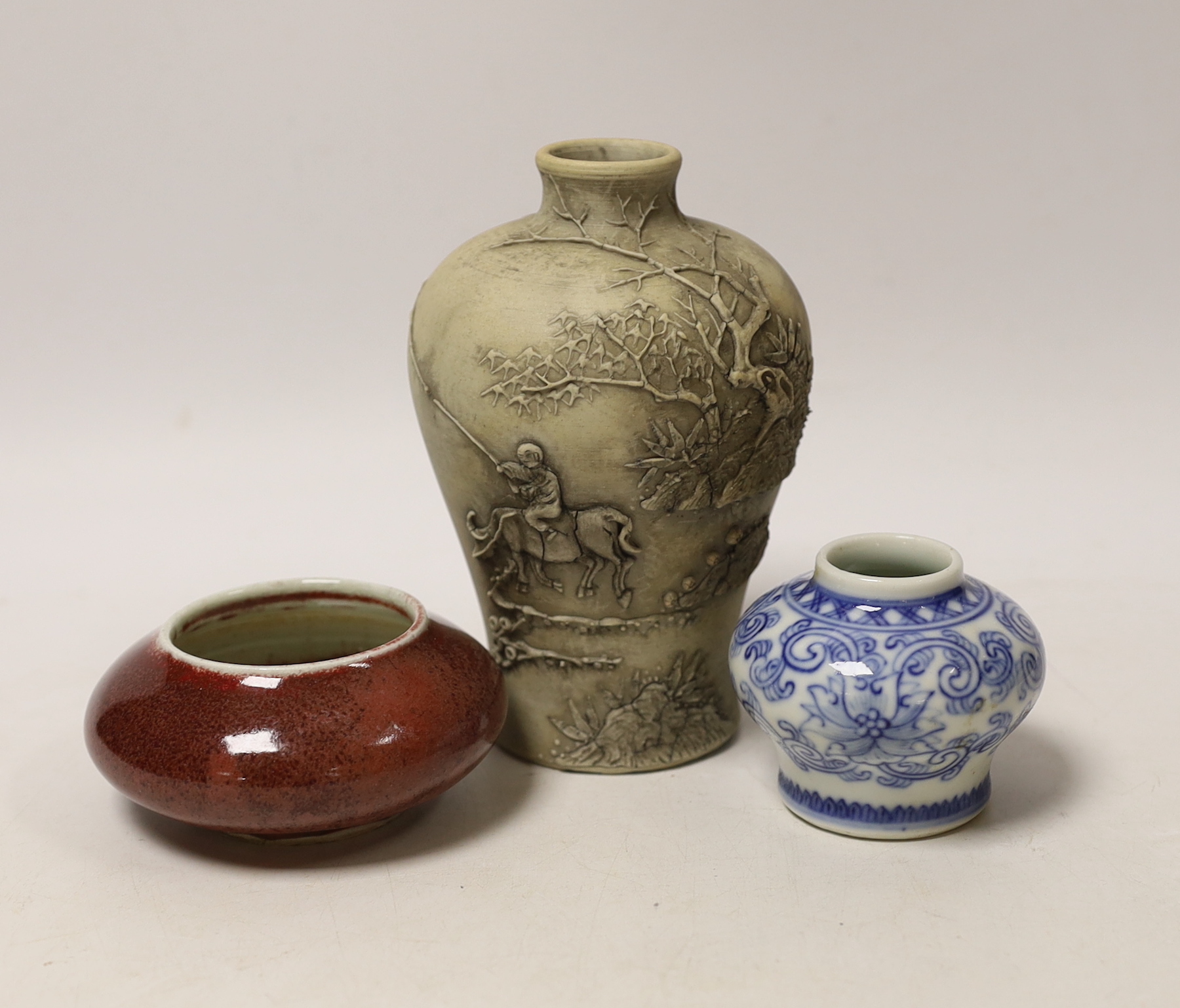 A Chinese sang de boeuf brush washer, a miniature blue and white vase and another vase, largest 14cm high
